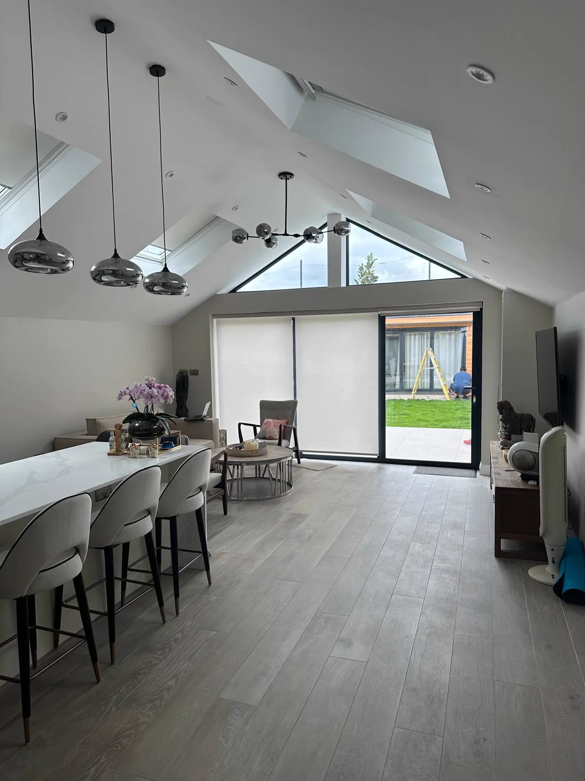 Completed vaulted open-plan kitchen, dining, and living space facing the garden